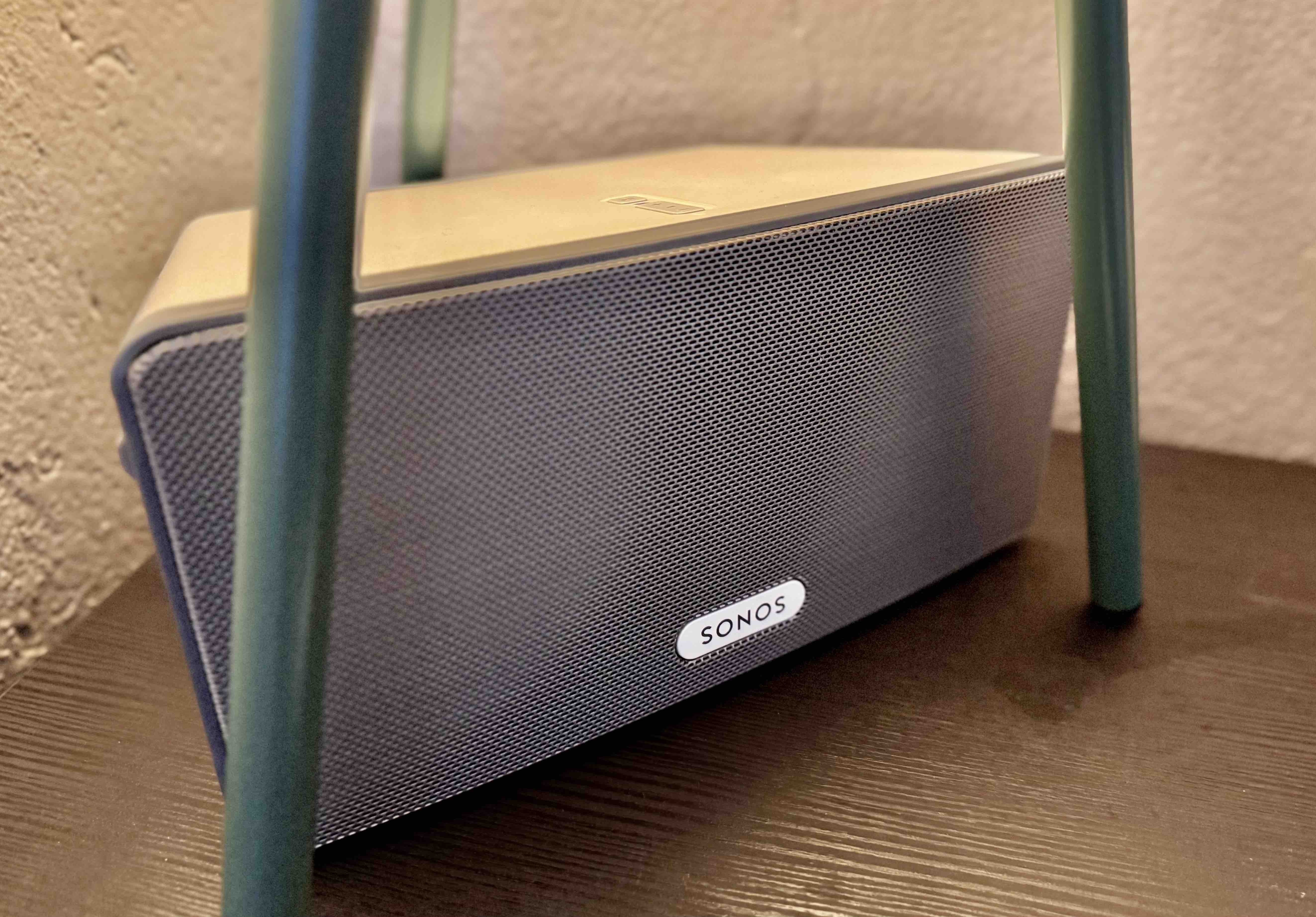 Photo of a Sonos speaker under a lamp with three green legs